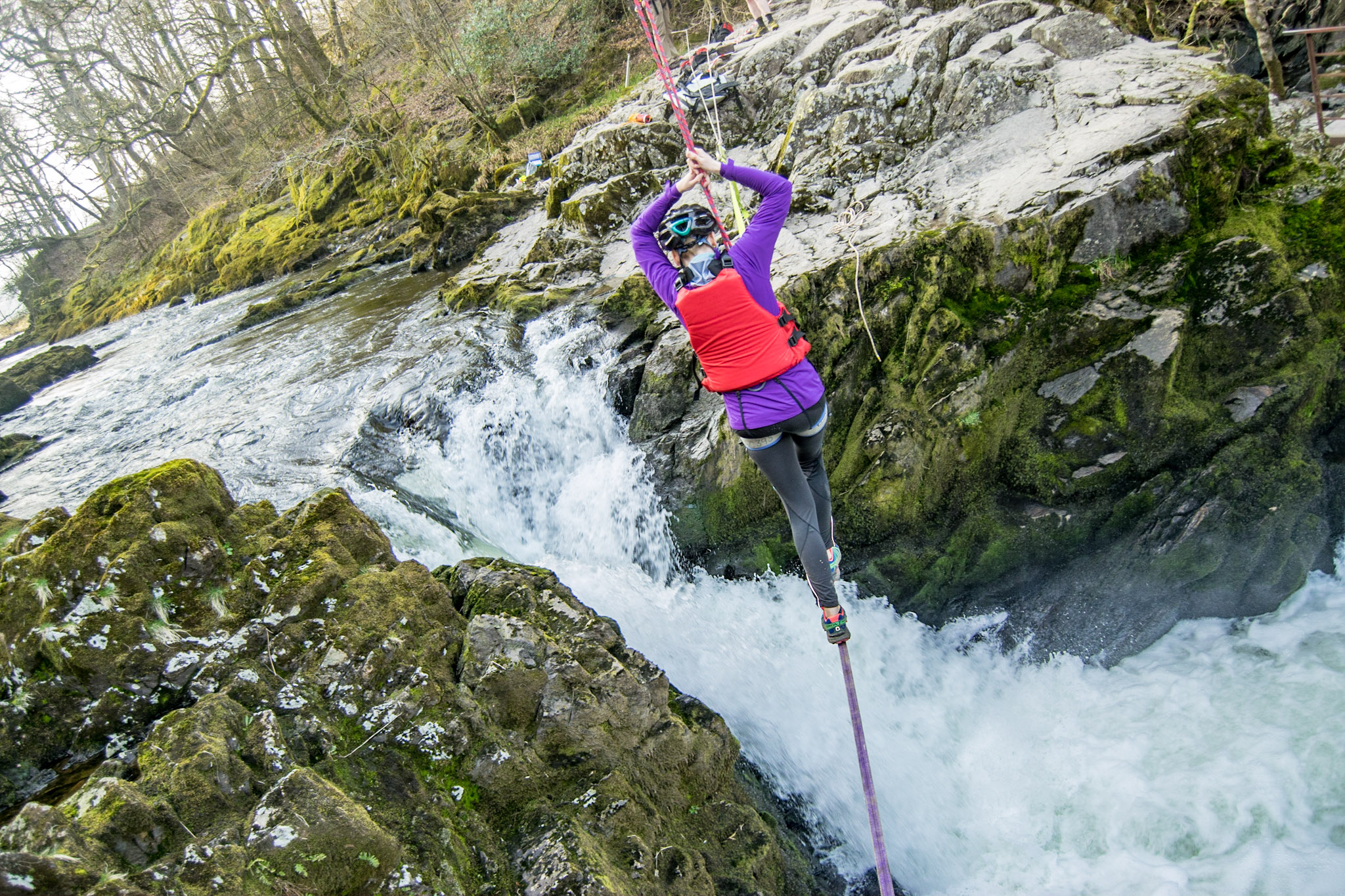 Student walking on tightrope across a waterfall Student walking on tightrope across a waterfall
