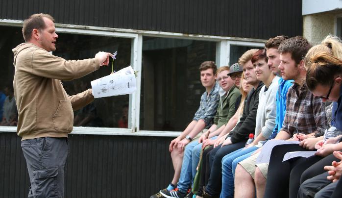 Students learning from a lecturer. Students learning from a lecturer.
