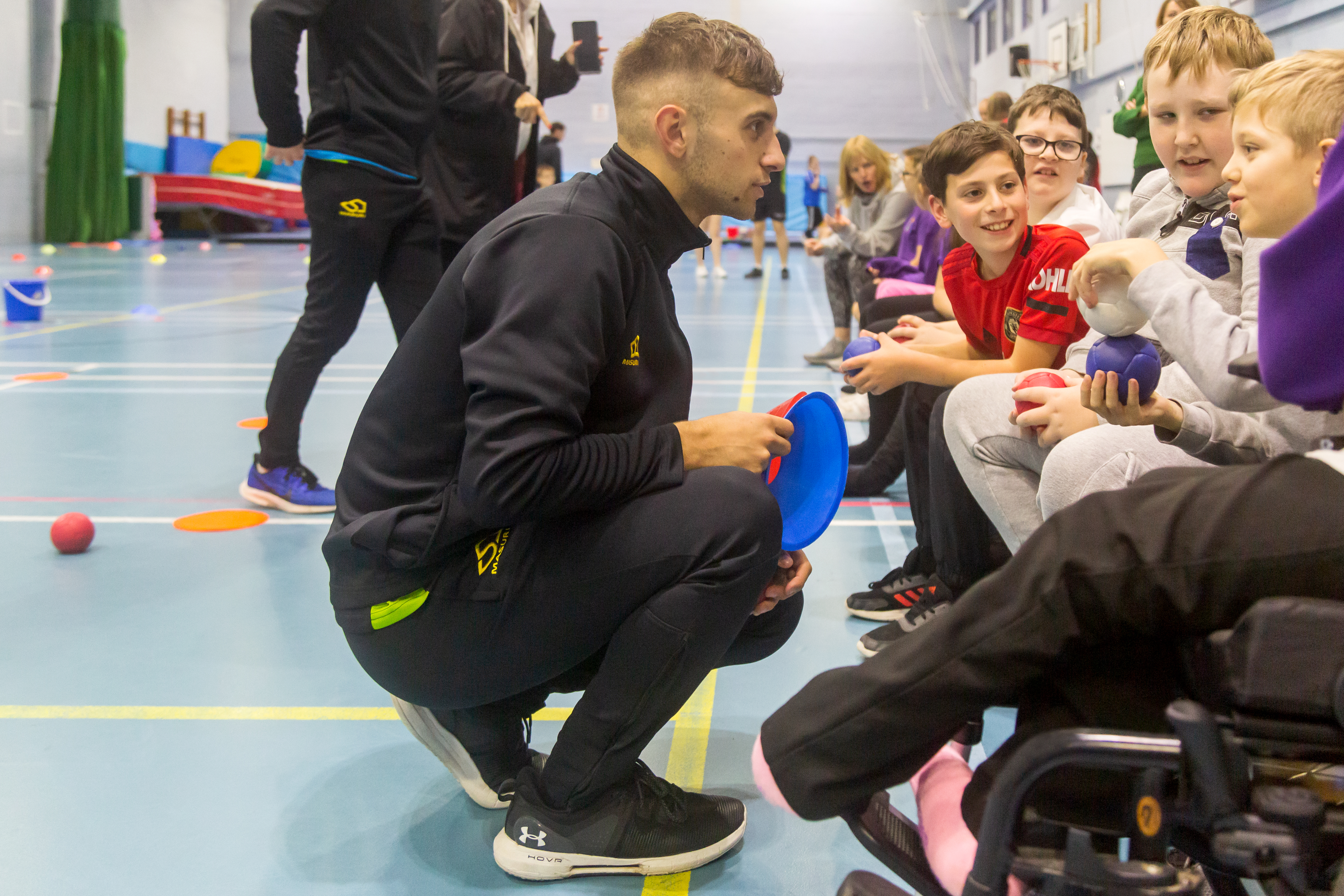 Sport students coaching school children as part of an event they've organised Sport students coaching school children as part of an event they've organised