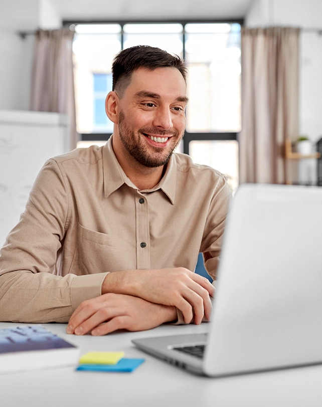 male teacher on a laptop