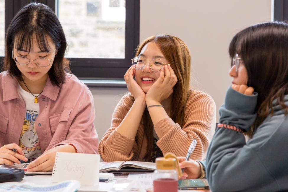 Three international students studying.