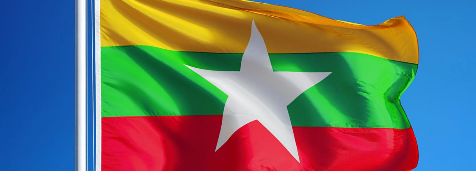 Flag of Myanmar on a flagpole.