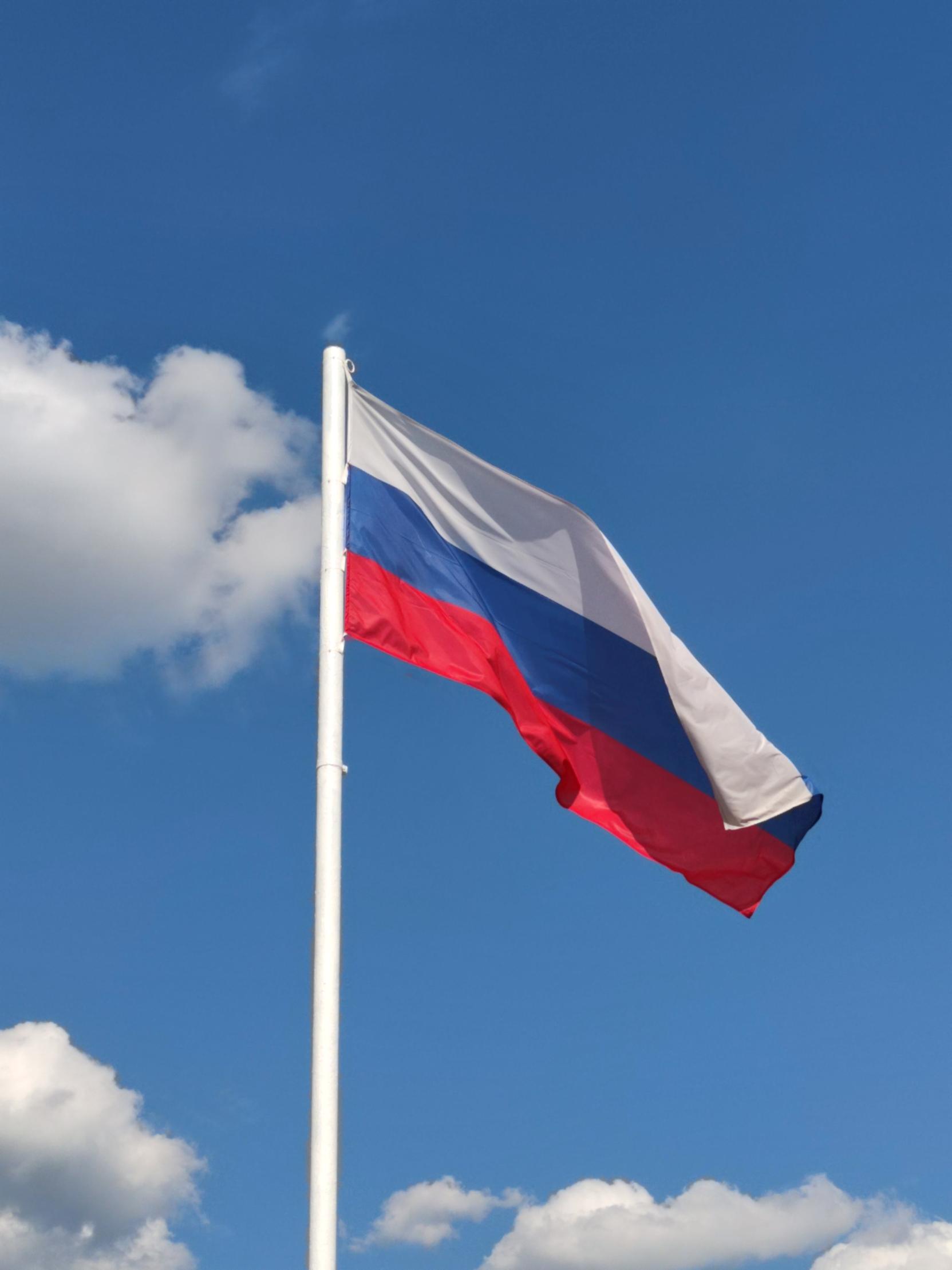 A Russian flag on a flagpole.