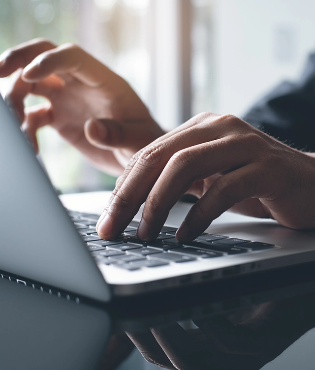 hands on a laptop