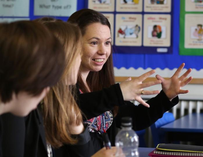 A teacher explains something to a class